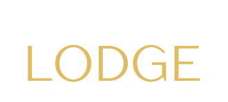 the logo for the lodge at porter ranch
